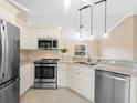 Modern kitchen features stainless steel appliances, granite countertops, and ample cabinet space at 3348 Trapper Ln, North Port, FL 34286