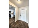 Bright entryway with wood floors leading into the kitchen with stainless steel appliances at 345 Three Lakes Ln # L, Venice, FL 34285