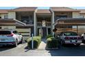 Charming condo exterior features assigned parking, well-maintained landscaping, and inviting stairways to upper units at 630 Bird Bay E Dr # 208, Venice, FL 34285