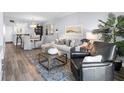 Bright living room with a plush sofa, decorative pillows, art, and large windows for natural light, creating a warm ambiance at 995 Laguna Drive # 303, Venice, FL 34285