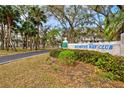 Bimini Bay Club entrance sign surrounded by lush landscaping and mature trees at 1051 Forrest Nelson Blvd # A-103, Port Charlotte, FL 33952