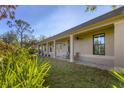 Well-maintained exterior features a covered porch and lush landscaping at 1115 Gladstone Blvd, Englewood, FL 34223