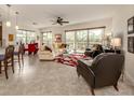 Bright living room with large windows, a ceiling fan, and comfortable seating at 142 Bella Vista Ter # A, North Venice, FL 34275