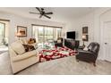 Cozy living room with natural light, comfortable seating and access to a screened lanai at 142 Bella Vista Ter # A, North Venice, FL 34275