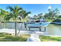 This home features a private boat lift and dock perfect for waterfront enjoyment at 2 Windsor Dr, Englewood, FL 34223