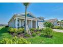 Quaint one-story home featuring lush landscaping, healthy lawn, and a two-car garage at 20420 Symphony Pl, Venice, FL 34293