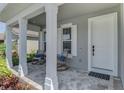 Inviting front porch with brick pavers and rocking chairs at 20420 Symphony Pl, Venice, FL 34293