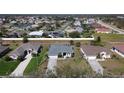 Aerial view of residences with well-manicured lawns, driveways, and streets in a peaceful neighborhood at 2115 Pan American Blvd, North Port, FL 34287