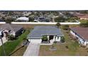 Exterior shot of a well-maintained single-story home with a lush green lawn and a welcoming entrance at 2115 Pan American Blvd, North Port, FL 34287