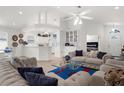 Open-concept living room with neutral color palette, tile floors, and comfortable seating, creating a welcoming and bright space at 213 Venice Palms Blvd, Venice, FL 34292