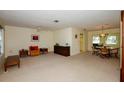 Spacious living room with carpet flooring and an adjacent dining area, perfect for entertaining at 2221 Bal Harbour Dr, Venice, FL 34293