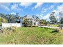 Beautiful two-story house showcasing a metal roof and a charming wrap-around balcony at 2371 Scenic Dr, Venice, FL 34293