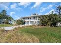 Charming two-story house with a metal roof and wrap-around balcony nestled in a scenic location at 2371 Scenic Dr, Venice, FL 34293