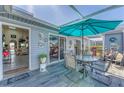 Outdoor patio with seating and an umbrella, perfect for relaxing or dining al fresco with direct access to the house at 3300 Loveland Blvd # 1201, Punta Gorda, FL 33980