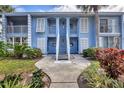 Two-story condo featuring white stairs and shuttered windows at 454 Cerromar Rd # 172, Venice, FL 34293
