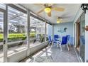 Screened-in patio area with ceiling fans and outdoor furniture at 454 Cerromar Rd # 172, Venice, FL 34293