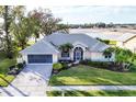 Beautiful single-story home with landscaped yard, and attached two-car garage at 5051 Greenway Dr, North Port, FL 34287