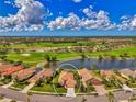 Aerial view of home in community near golf course and lake at 5151 Pine Shadow Ln, North Port, FL 34287