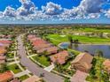 Aerial view of house in a golf community next to a pond at 5151 Pine Shadow Ln, North Port, FL 34287