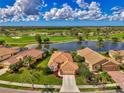 Aerial view of home with golf course and water view at 5151 Pine Shadow Ln, North Port, FL 34287