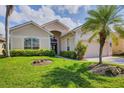 Lovely home with a manicured lawn, mature palm trees and a welcoming entrance at 560 Misty Pine Dr, Venice, FL 34292