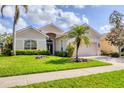 Charming single-story home with lush landscaping, a well-kept lawn, and a welcoming entrance at 560 Misty Pine Dr, Venice, FL 34292