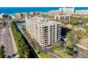 Aerial shot of the condo building on a bright, sunny day near the beach, and waterway at 6415 Midnight Pass Rd # 909, Sarasota, FL 34242