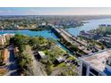 Expansive water view with a bridge, a canal, and colorful buildings in the distance on a clear day at 6415 Midnight Pass Rd # 909, Sarasota, FL 34242