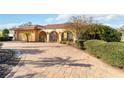 Spacious brick driveway and well-maintained landscaping surrounding the Mediterranean-style home at 6427 Canary St, Sarasota, FL 34241