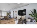 Bright living area offers comfortable seating, entertainment center, and view of the open floor plan at 648 Cypress Rd, Venice, FL 34293