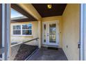 Inviting screened-in front entryway with a double-door entrance providing natural light at 781 Missouri Rd, Venice, FL 34293