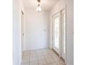 Bright entryway with white walls, tile flooring, and a decorative glass front door at 781 Missouri Rd, Venice, FL 34293