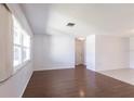 Bright living room featuring wood floors and large windows allowing for plenty of natural light at 781 Missouri Rd, Venice, FL 34293