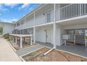 Two-story building with white railings, updated landscaping, and convenient access to entrances and amenities at 902 Gibbs Rd # 181, Venice, FL 34285