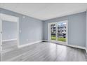 Serene living room with hardwood floors and slider doors leading to waterfront views and canal access at 902 Gibbs Rd # 181, Venice, FL 34285