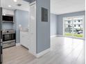 Well-lit kitchen and open floor plan with a sliding glass door and view of the water at 902 Gibbs Rd # 181, Venice, FL 34285