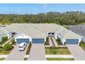 An aerial view of a well-maintained single-story home with a spacious driveway and green landscaping at 9916 Bright Water Dr, Englewood, FL 34223