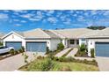 Well-maintained single-story home with a two-car garage and manicured landscaping at 9916 Bright Water Dr, Englewood, FL 34223