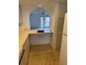 Kitchen featuring a cutout looking into the living room area at 104 Capri Isles Blvd # 303, Venice, FL 34292