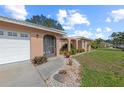View of the front of the house, with a two-car garage, walkway, and well-maintained landscaping at 107 Corot Dr, Nokomis, FL 34275
