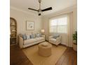 Cozy sitting room with neutral tones, natural lighting and wood flooring at 10768 Trophy Dr, Englewood, FL 34223