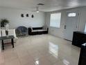 Bright living room featuring tile floors, modern furniture, and ample natural light creates a welcoming space at 12613 4Th Isle, Hudson, FL 34667