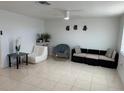 Open living room with tile flooring, ceiling fan, and contemporary decor offers a versatile living space at 12613 4Th Isle, Hudson, FL 34667