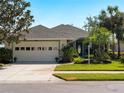 Beautiful home with a well-maintained lawn, mature landscaping and a two car garage at 154 Coco Palm Dr, Venice, FL 34292