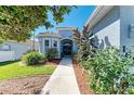 Charming home featuring a landscaped walkway leading to the front door at 161 Valencia Lakes Dr, Venice, FL 34292