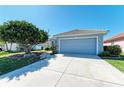 Well-maintained home with a spacious driveway and lush landscaping at 161 Valencia Lakes Dr, Venice, FL 34292