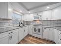 Bright kitchen featuring white cabinets, granite countertops, subway tile backsplash, and stainless steel appliances at 1703 Bal Harbour Dr # 2, Venice, FL 34293