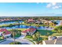 Scenic aerial view of a waterfront community with houses surrounding tranquil lakes at 217 Savona Way, North Venice, FL 34275