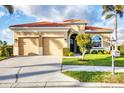 Charming home featuring a two-car garage, well-manicured lawn, and elegant front entrance at 217 Savona Way, North Venice, FL 34275