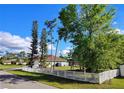 Wide open and spacious backyard enclosed with a white vinyl fence, offering plenty of room for recreation and relaxation at 23495 Altman Ave, Punta Gorda, FL 33980